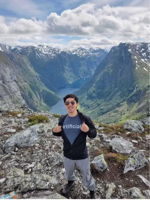 Product manager Moe on top of a big mountain somewhere